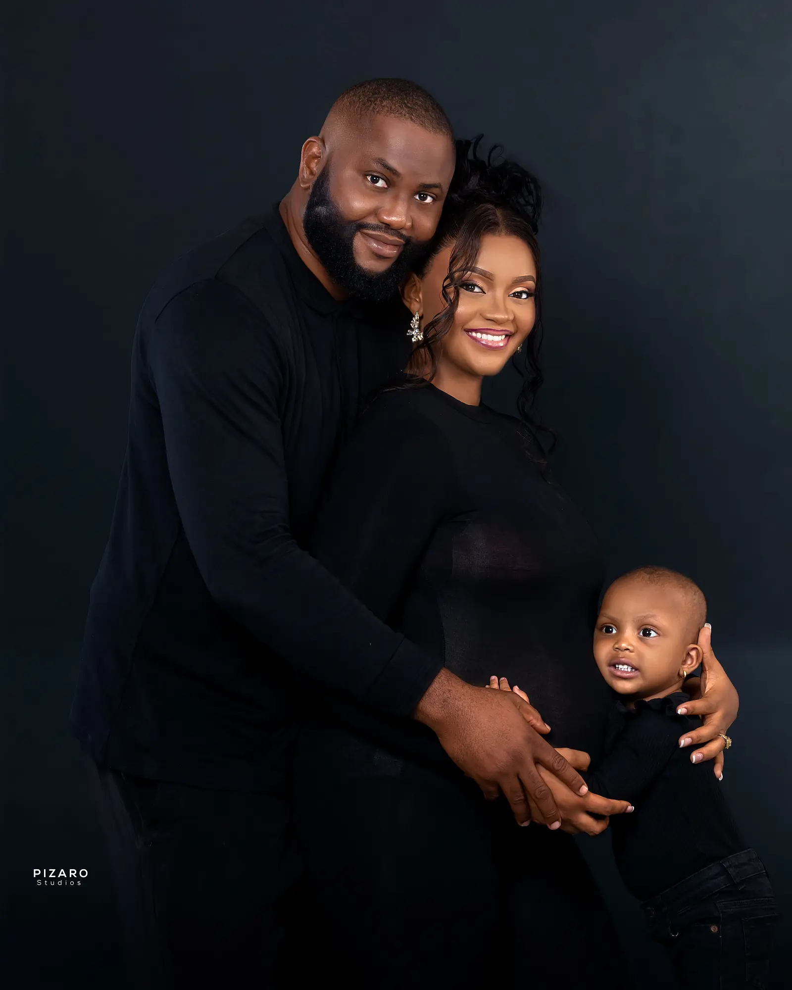 Pizaro Studios maternity session — elegant family of three in all black