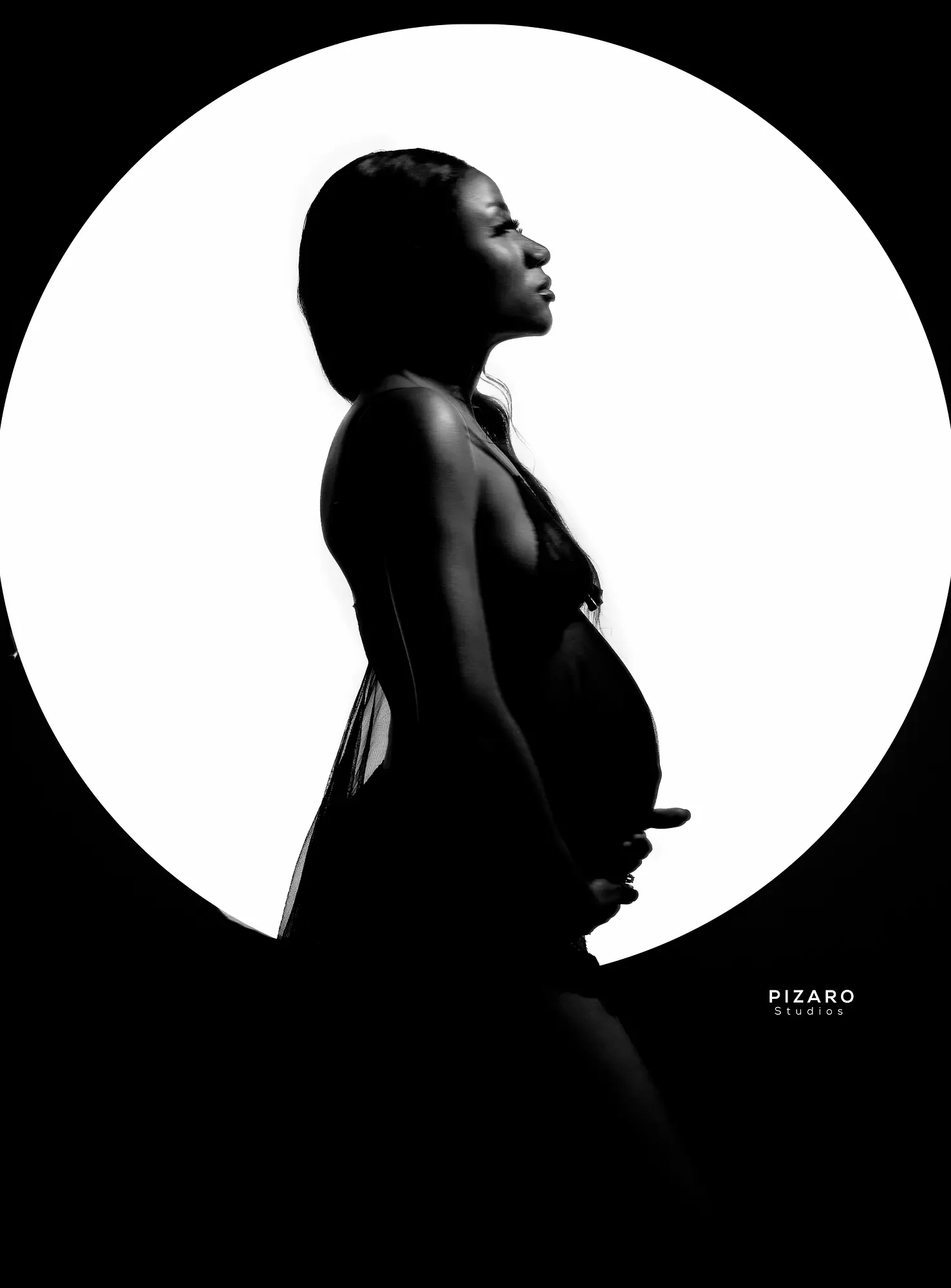Pizaro Studios maternity session — black-and-white bump silhouette in a luminous circle