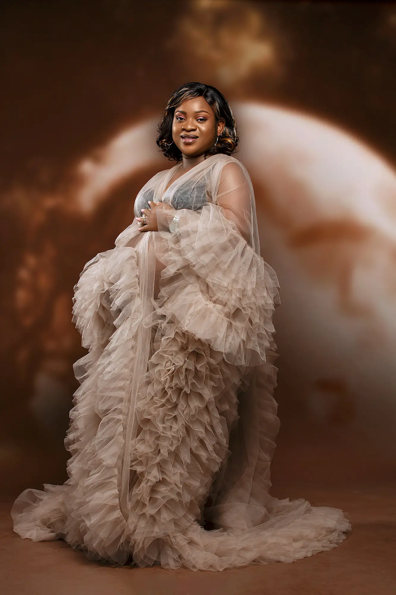 Pizaro Studios maternity session — seated glamour portrait in flowing beige tulle