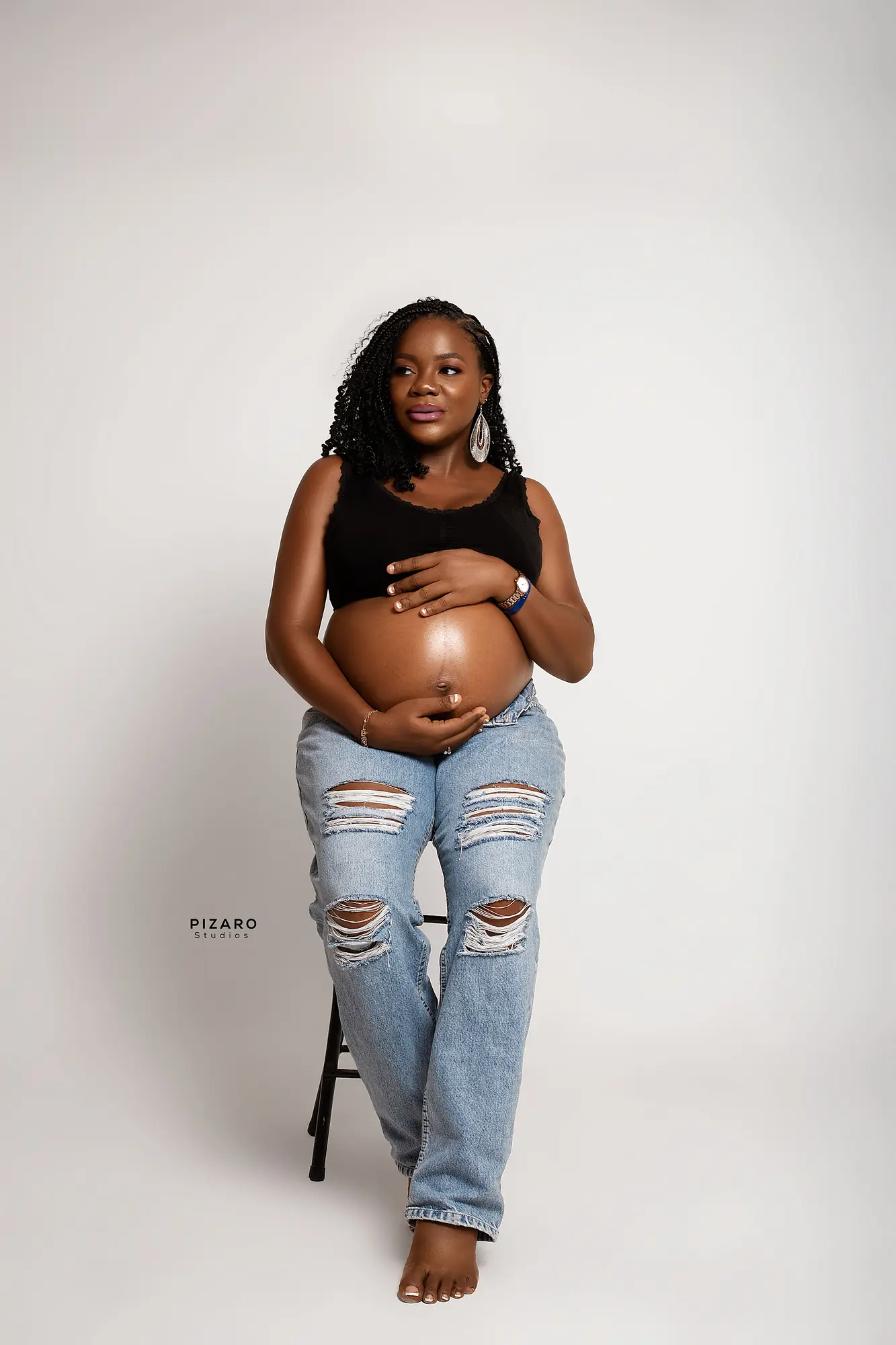 Pizaro Studios maternity session — relaxed denim and crop-top lifestyle portrait