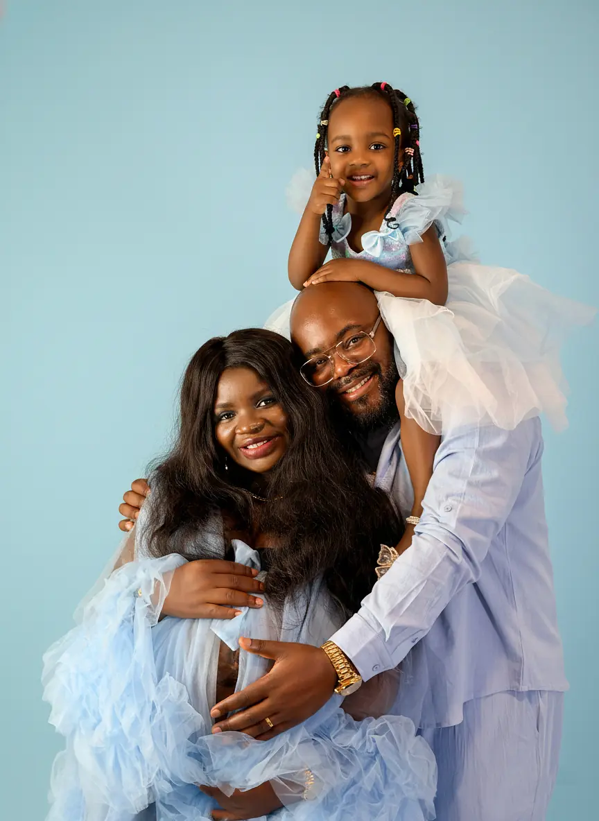 Pizaro Studios maternity session — joyful family of three in powder blue