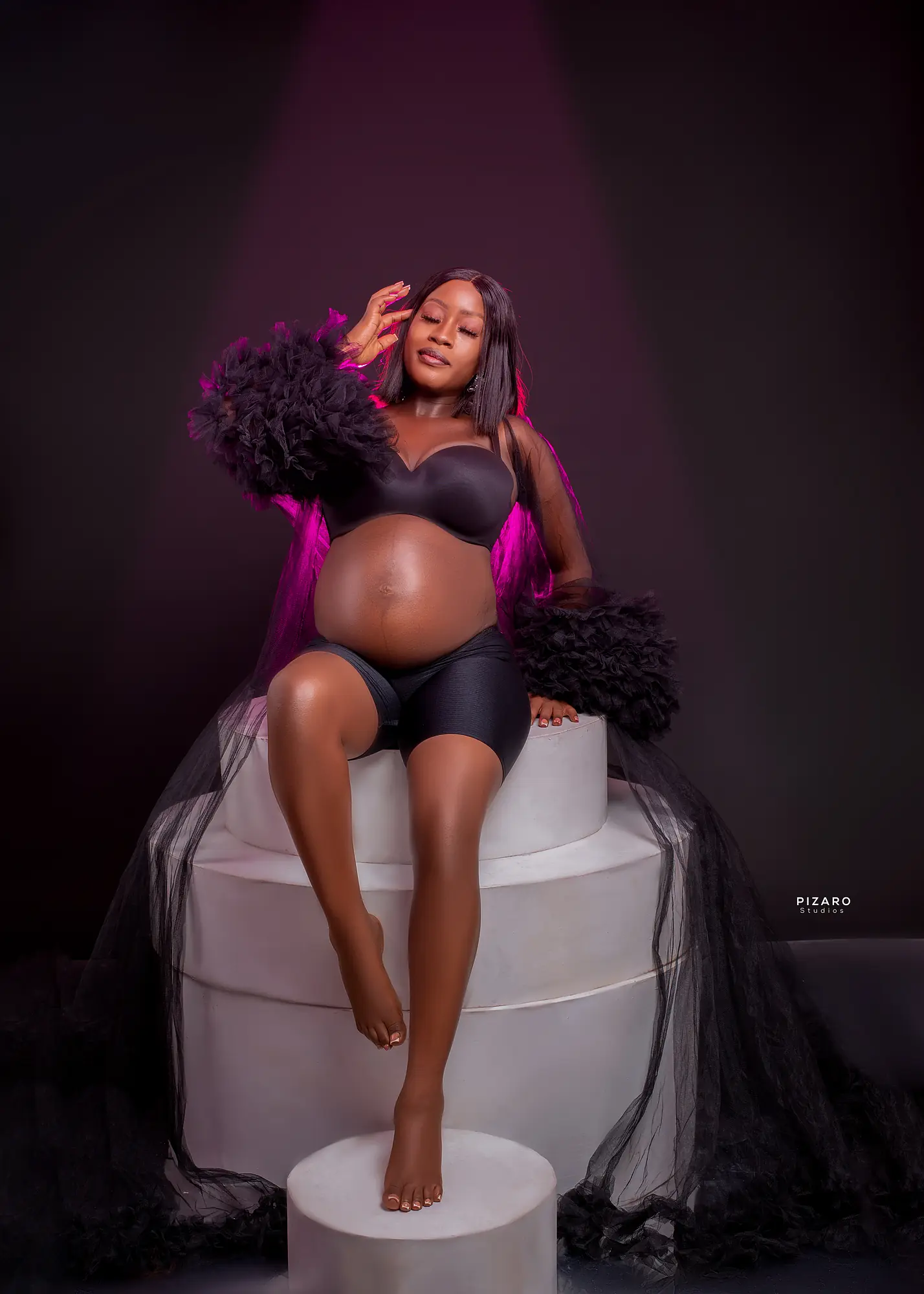 Pizaro Studios maternity session — black tulle glamour under magenta gel light